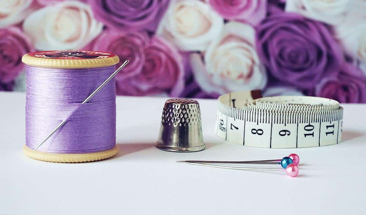 Purple thread and a needles and thimble